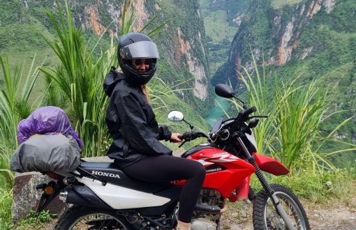 Motorbiking in Vietnam - A girl on a motorbike in front of a stunning landscape in the north